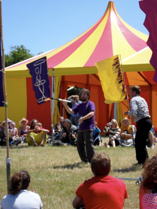 Fire juggling daylight show at a festival